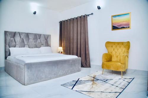 萊基的住宿－Oasis Villa Lekki，一间卧室配有一张床和一把椅子