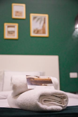 a pile of towels sitting on top of a bed at Hathor House in Cairo
