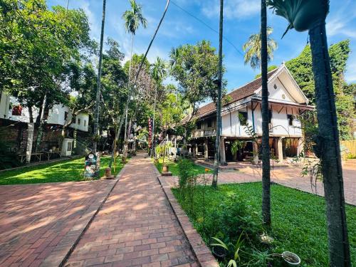 a brick road in front of a building at Thatsaphone Hotel in Luang Prabang