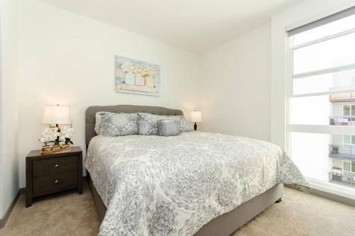 a white bedroom with a bed and a window at Lovely 3bed Apt with pool close to SD Convetion Center 324 in San Diego