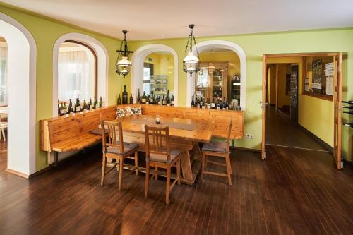 a dining room with a large wooden table and chairs at Breitenfelderhof zur Riegersburg in Breitenfeld an der Rittschein