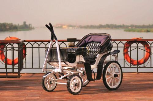 a baby carriage parked on a dock near a body of water at Movenpick SS Misr Steamer Nile Cruise - 04 & 07 Nights Each Monday From Luxor and 03 Nights Each Friday from Aswan in Luxor