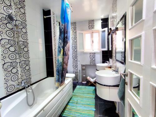 a bathroom with a tub and a sink and a toilet at Appartement richement meublé a Sidi Bou Said in Sidi Bou Saïd