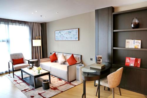 a living room with a couch and a table at Zhuo Ruiyunrui Hotel in Dongliucun