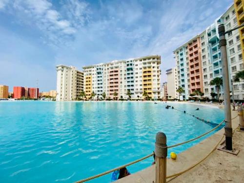 a large swimming pool in front of some buildings at Sia Lagoon 2 BR Porto Golf Marina Apartment with Garden Families only in El Alamein