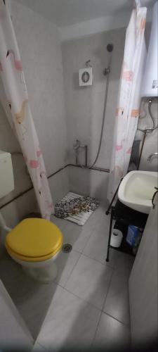 a bathroom with a yellow toilet and a sink at Pilion-Unique House at the Aegean Sea in Keramídhion