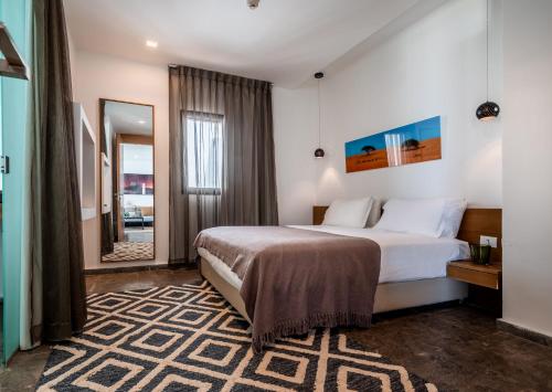 a hotel room with a bed and a mirror at Jacob Sea Life Nahariya in Nahariyya