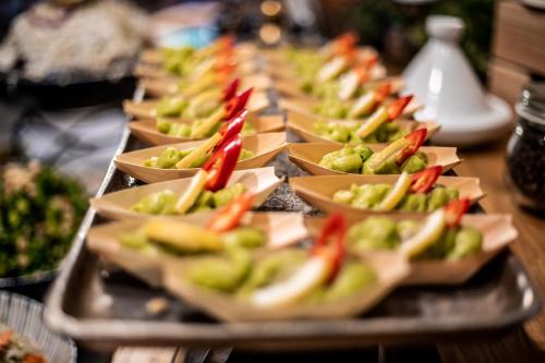 a row of appetizers on a tray on a table at Jacob Sea Life Nahariya in Nahariyya
