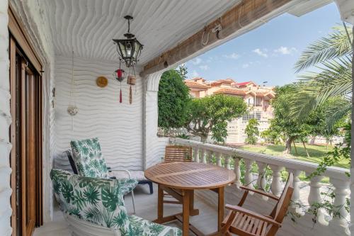 a balcony with a table and chairs and a view at Casa en la playa con piscinas A in Puerto Marino