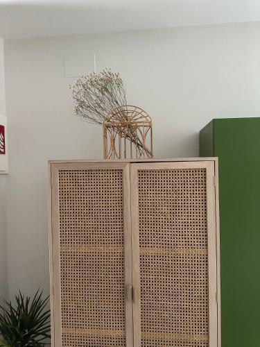 a wooden cabinet with a basket on top of it at Amodiño do Camiño in Belesar
