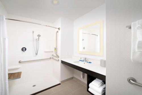 a white bathroom with a sink and a shower at Holiday Inn Express & Suites - North Brunswick, an IHG Hotel in North Brunswick