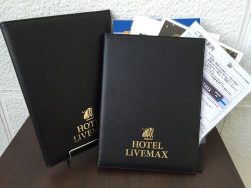 two black boxes sitting on top of a table at HOTEL LiVEMAX Okayama in Okayama