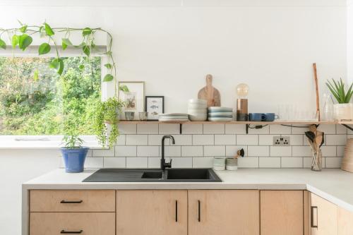 a kitchen with a sink and a window at Number 4 - Stylish 1 bedroom house in Truro, Cornwall in Truro