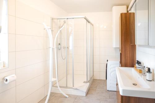 a bathroom with a shower and a sink at Haus Bachinger in Mondsee