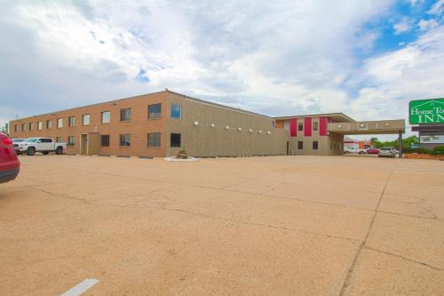 a large building with a parking lot in front of it at HomeTown Inn By OYO - Liberal, KS in Liberal