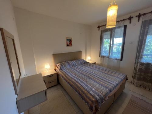 a small bedroom with a bed and two night stands at Chic Villa with Terrace and Rooftop in Izmir in Izmir