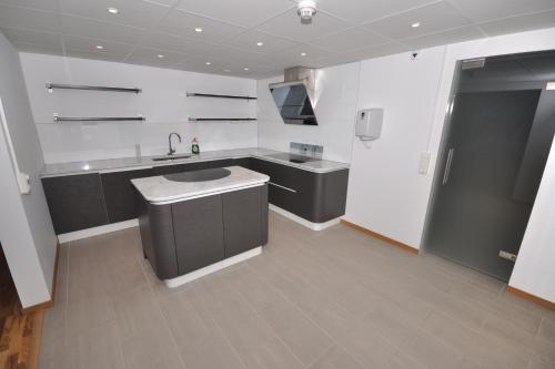 a large kitchen with a sink and a refrigerator at Brandbergens Vandrarhem in Haninge