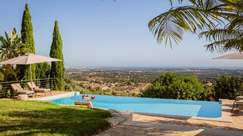 a swimming pool in a villa with a view at Villa Mebahel - Boliqueime in Boliqueime