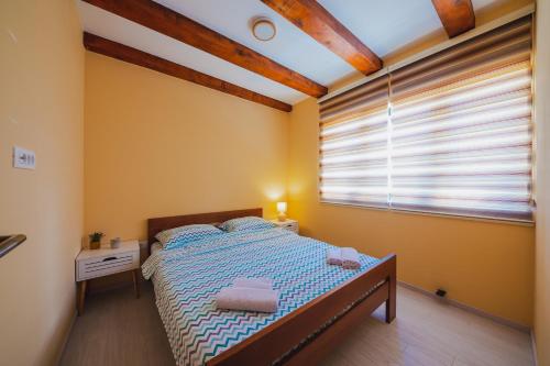 een slaapkamer met een bed en een raam bij Vila Rea in Žabljak