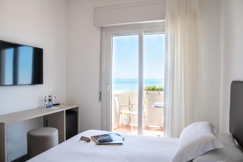 Postel nebo postele na pokoji v ubytování Hotel Villa Sorriso