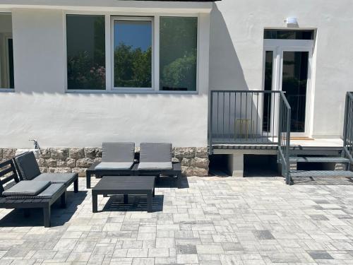 a patio with chairs and tables and a building at Casa Teresa in Riva del Garda