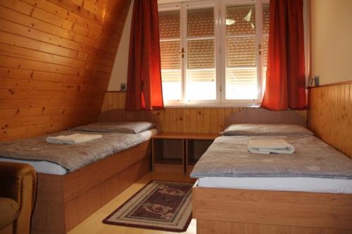 a bedroom with two beds and a window at U Mami in Veľký Meder