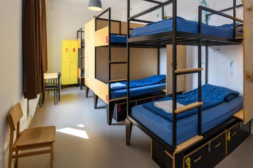 a room with three bunk beds in a dorm at Stayokay Hostel Utrecht Centrum in Utrecht