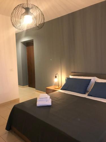 a bedroom with a bed with two towels on it at BaCar b&b in Quattromiglia