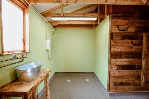 a bathroom with a trough sink and a shower at Heydon Grove Farm by Feather Down in Heydon