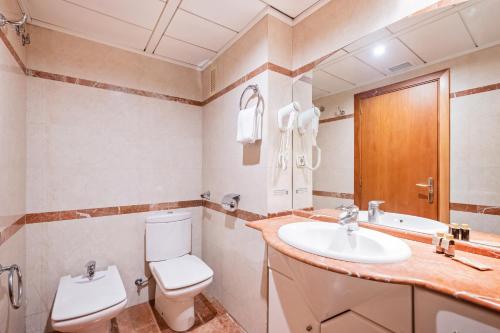 a bathroom with a toilet and a sink at Apartaments Marina - Abapart in Barcelona