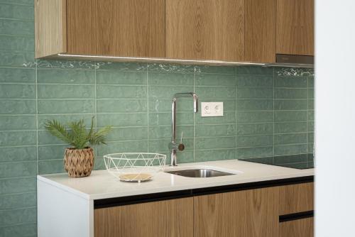 a kitchen with a sink and a plant on a counter at Miral 5 Sea front by HD Properties in Quarteira