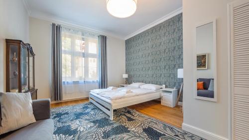 a bedroom with a bed and a large window at Apartamenty Sun & Snow Parkowa in Sopot