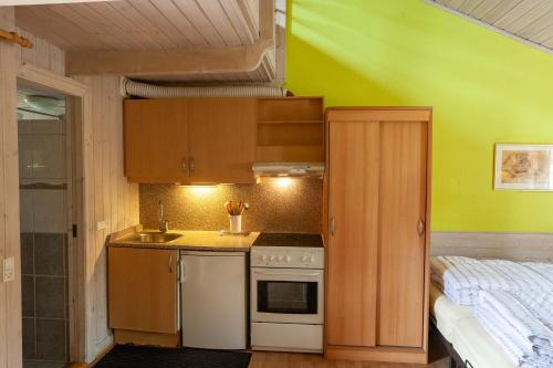 a small kitchen with a sink and a stove at Randbøldal Camping & Cabins in Randbøl