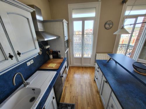 a kitchen with a sink and a counter top at Les 5 balcons in Le Tréport