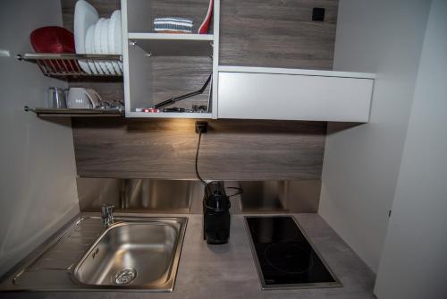 a kitchen with a sink and a counter top at Corte Paradiso in Turin