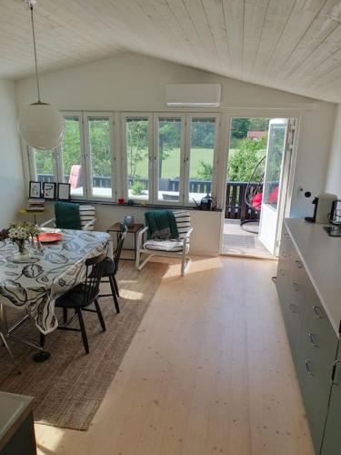 a kitchen and living room with a table and chairs at Stugan in Stockholm