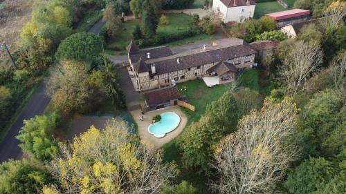 an aerial view of a house with a swimming pool at Domaine de la Source in Sainte-Christie-dʼArmagnac