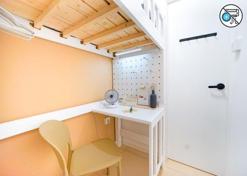 a small room with a desk and a chair at Shared Room at Lockhart Road 414 in Hong Kong