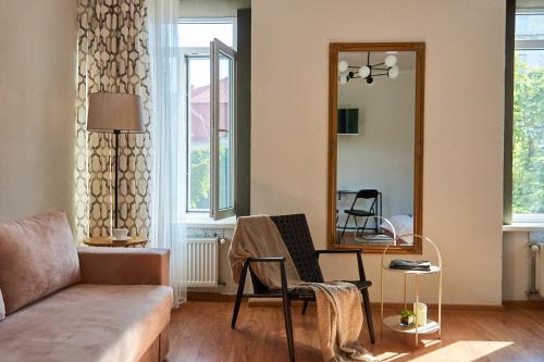 a living room with a couch and a mirror at Best Apartments on Kyryla & Mefodia in Mukacheve