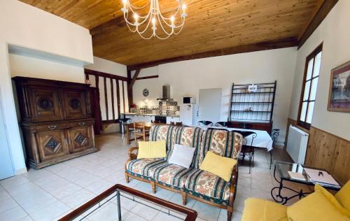 a living room with a couch and a table at Domaine de la Source in Sainte-Christie-dʼArmagnac