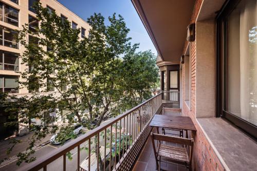 a balcony with a wooden bench and a window at Aparthotel Napols - Abapart in Barcelona