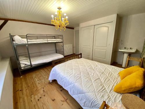 a bedroom with a bunk bed and a chandelier at Domaine de la Source in Sainte-Christie-dʼArmagnac