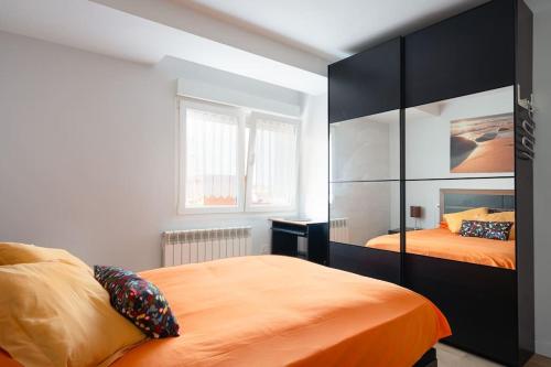 a bedroom with two beds and a large closet at MyHouseSpain - Moderno piso frente al mar in Gijón
