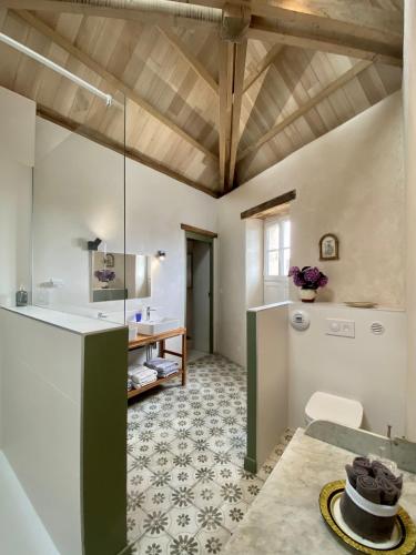 Il comprend une cuisine équipée d'un réfrigérateur et d'une table. dans l'établissement Le Presbytère, à Tréffiagat