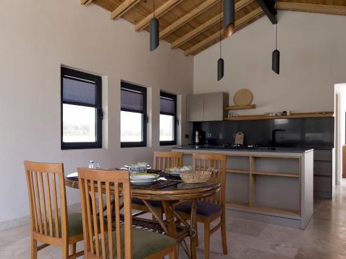 a kitchen with a wooden table and chairs in a room at Koy Villa in Muğla