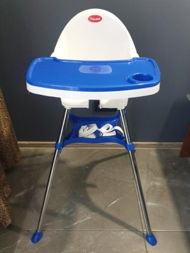 a blue and white high chair with a hat on it at New apartment 1 in Lviv