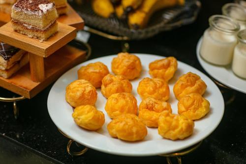a white plate of food on a table at Hanoi La Palm Premier Hotel & Spa in Hanoi