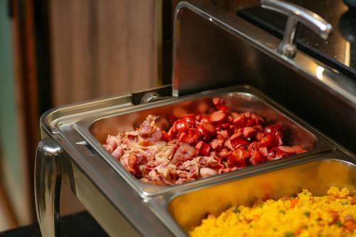 a pan of food is being cooked in an oven at Hanoi La Palm Premier Hotel & Spa in Hanoi