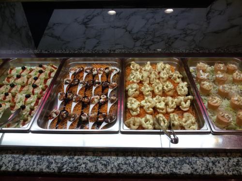 a display case with many different types of pastries at Cleopatra Spa Hotel in Lloret de Mar