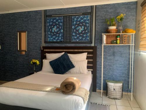a bedroom with a bed with a hat on it at Tintswalo Nests in Johannesburg